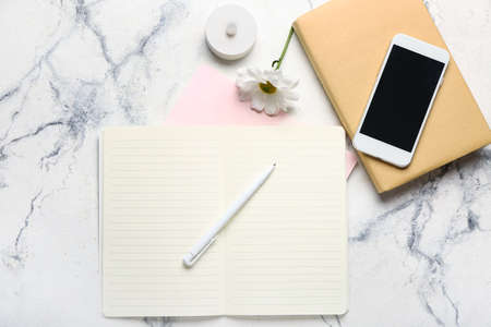 Composition with notebooks, pen and mobile phone on light backgroundの写真素材