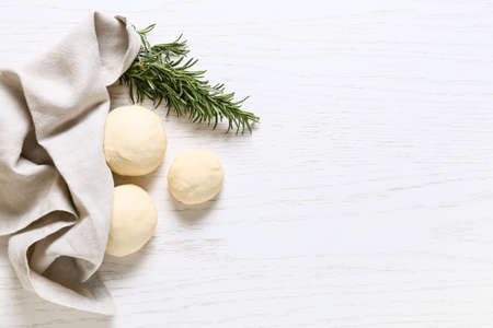 Fresh dough and rosemary on light wooden backgroundの写真素材
