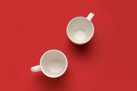 Empty cups on color background