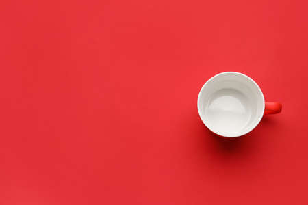 Empty cup on color backgroundの写真素材