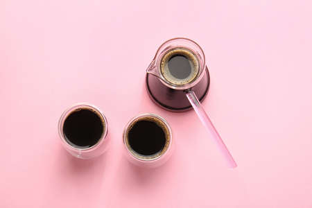Cezve and cups of turkish coffee on color backgroundの写真素材