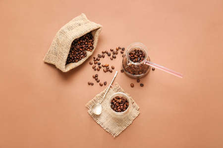 Composition with coffee beans on color background