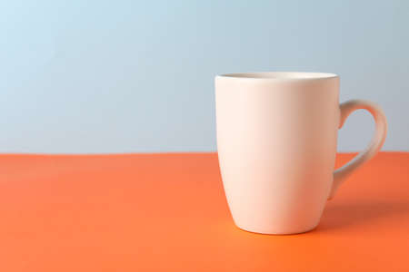 Empty cup on color backgroundの写真素材