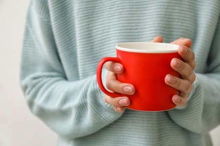 Woman with cup of hot tea, closeupの写真素材