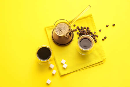 Cezve and cups of turkish coffee on color backgroundの写真素材