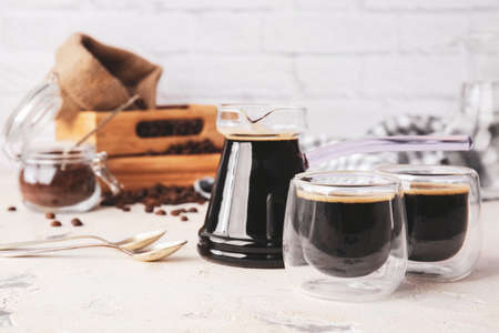 Cezve and cups of turkish coffee on table