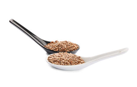 Spoons with flax seeds on white backgroundの写真素材