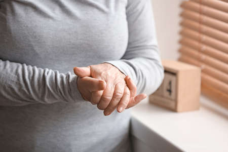 Hands of elderly woman at homeの写真素材