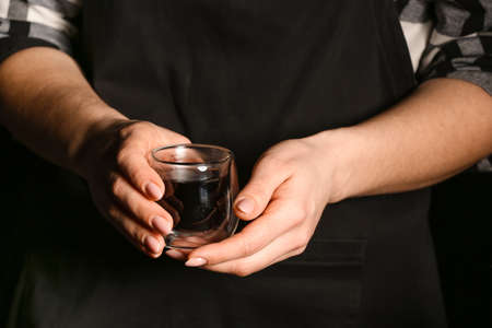 Female barista with cup of delicious turkish coffee, closeup