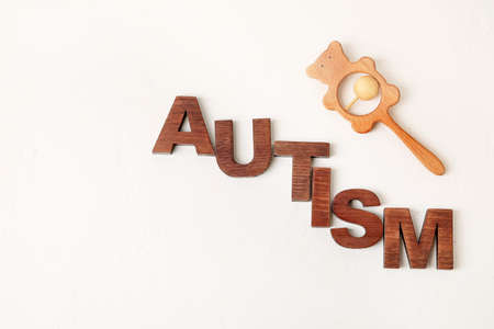 Word AUTISM and rattle on white backgroundの写真素材
