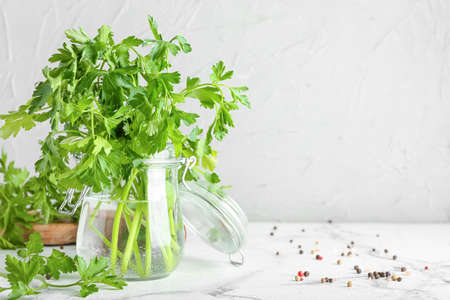 Jar with fresh parsley on light backgroundの写真素材