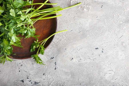 Plate with fresh parsley on gray backgroundの写真素材