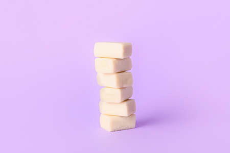 Tasty chewing gums on color background