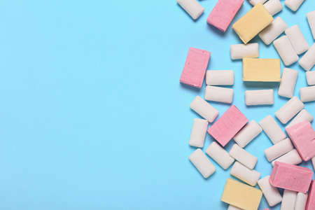 Tasty chewing gums on color background