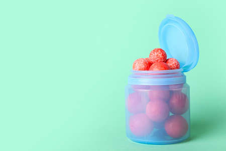 Jar with tasty chewing gums on color backgroundの写真素材