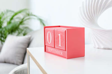 Cube calendar with date SEPTEMBER 1 on table in room