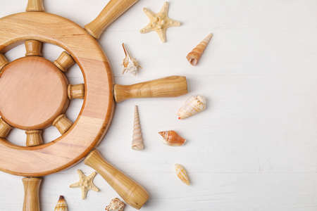 Helm and sea shells on wooden background