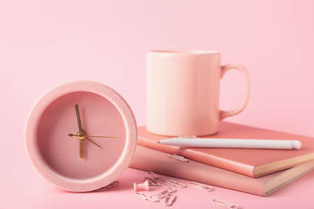 Composition with alarm clock, cup and stationery on color backgroundの写真素材