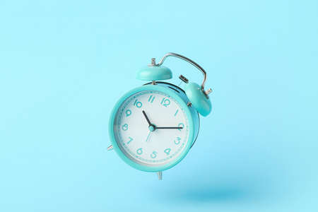 Alarm clock on color background