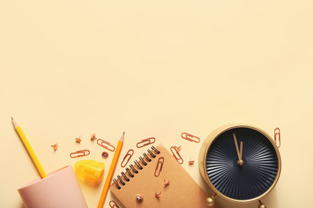 Composition with alarm clock and stationery on color backgroundの写真素材