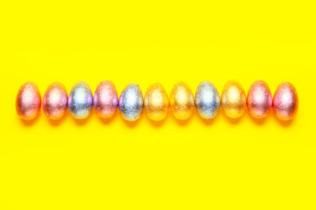 Sweet chocolate eggs on color background