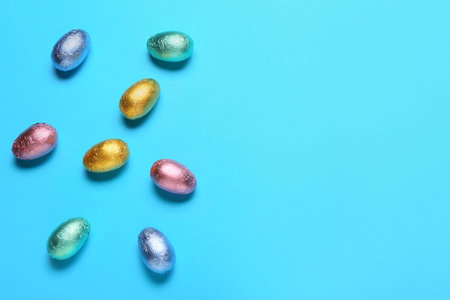 Sweet chocolate eggs on color backgroundの写真素材