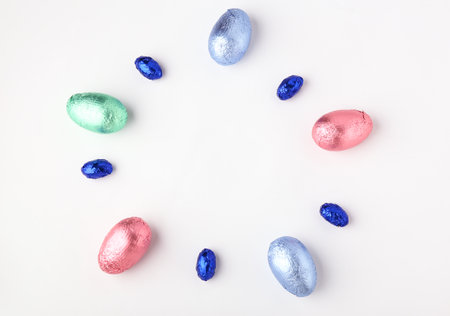 Sweet chocolate eggs on white background