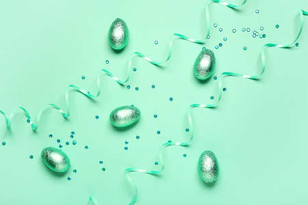 Sweet chocolate eggs on color backgroundの写真素材