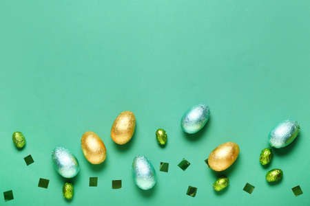 Sweet chocolate eggs on color backgroundの写真素材