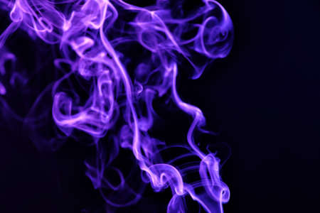 Color smoke on dark backgroundの写真素材