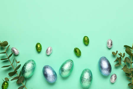 Sweet chocolate eggs on color backgroundの写真素材