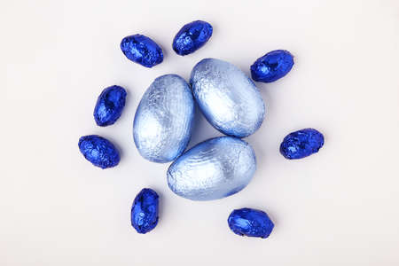 Sweet chocolate eggs on white background