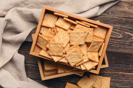Box of crackers on wooden background
