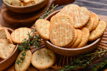 Bowl with crackers on wooden backgroundの写真素材