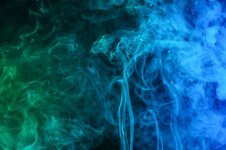 Color smoke on dark backgroundの写真素材