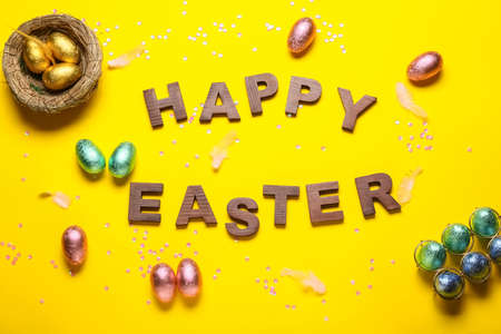 Composition with sweet chocolate Easter eggs on color backgroundの写真素材