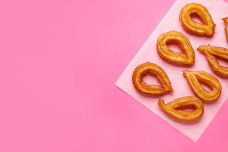Parchment with tasty churros on color backgroundの写真素材