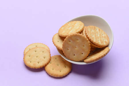 Bowl of crackers on color backgroundの写真素材