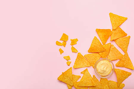 Tasty nachos with sauce on color backgroundの写真素材