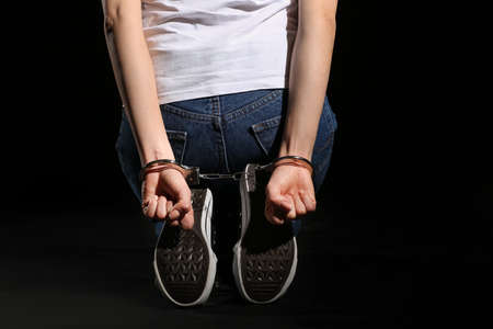 Female hostage on dark background
