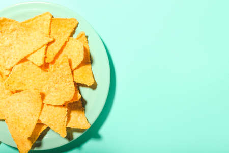 Plate with tasty nachos on color backgroundの写真素材