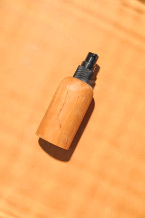 Bottle of cosmetic product on color backgroundの写真素材