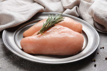 Plate with raw chicken fillet on gray background, closeupの写真素材