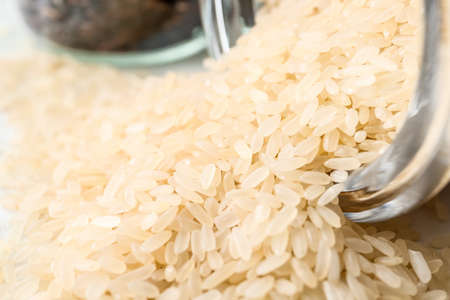 Overturned jar with raw rice, closeupの写真素材