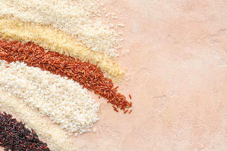 Different types of raw rice on color backgroundの写真素材