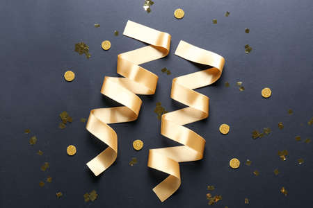 Beautiful golden ribbons on dark backgroundの写真素材