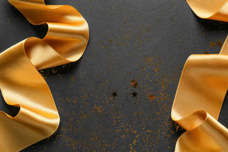 Beautiful golden ribbons on dark backgroundの写真素材