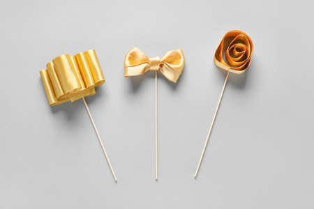 Composition with beautiful golden ribbons on light backgroundの写真素材