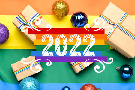Beautiful greeting card for Happy New Year 2022 with gifts and rainbow flag. LGBT concept