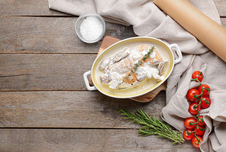 Baking dish with tasty chicken fillet on wooden backgroundの写真素材